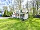 Inviting two-story home with a brick-accented facade, spacious lawn, and cozy front porch at 4223 Kestrel Ct, Indianapolis, IN 46254