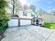 Two-story home with a brick-accented facade, an attached two-car garage, and an inviting front porch at 4223 Kestrel Ct, Indianapolis, IN 46254