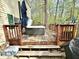 Outdoor deck featuring a hot tub, wooden railing, steps, and a partial view of the home's exterior at 4223 Kestrel Ct, Indianapolis, IN 46254