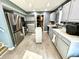 Well-lit kitchen featuring gray cabinetry, stainless-steel appliances, modern tile backsplash, and pantry space at 4223 Kestrel Ct, Indianapolis, IN 46254