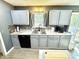 The modern kitchen includes stainless steel sink, updated countertops, and a light gray cabinet finish at 4223 Kestrel Ct, Indianapolis, IN 46254