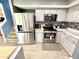 Updated kitchen with gray cabinets, stainless steel appliances, a tile backsplash, and modern fixtures at 4223 Kestrel Ct, Indianapolis, IN 46254