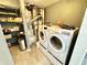 Large laundry room with washer, dryer, utility shelves, and plenty of room for storage at 4223 Kestrel Ct, Indianapolis, IN 46254