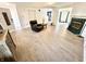 Open concept living room with modern flooring, a fireplace, and plenty of natural light at 4223 Kestrel Ct, Indianapolis, IN 46254
