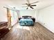 Spacious main bedroom with wood-look flooring, ceiling fan, and natural light at 4223 Kestrel Ct, Indianapolis, IN 46254