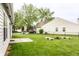 Large grassy backyard featuring a firepit area perfect for outdoor gatherings at 4303 Cowslip Ct, Indianapolis, IN 46203