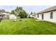Spacious backyard featuring green grass and a dedicated fire pit area, perfect for entertaining at 4303 Cowslip Ct, Indianapolis, IN 46203