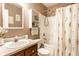 Charming bathroom with vanity, decorative mirror and shower with attractive floral curtain at 4303 Cowslip Ct, Indianapolis, IN 46203