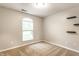 Inviting bedroom featuring a window for natural light and minimalist wall-mounted shelving at 4303 Cowslip Ct, Indianapolis, IN 46203