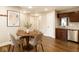 Inviting dining area with wood-look flooring next to a kitchen area with stainless appliances at 4303 Cowslip Ct, Indianapolis, IN 46203