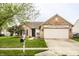 Charming single-story brick home with a well-manicured lawn and an attached two-car garage at 4303 Cowslip Ct, Indianapolis, IN 46203