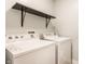 Functional laundry room with modern appliances, convenient shelf, and ample space at 4303 Cowslip Ct, Indianapolis, IN 46203