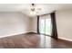 Bright living room with hardwood floors, fan, and sliding glass doors for ample light at 4303 Cowslip Ct, Indianapolis, IN 46203