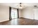 Bright living room with hardwood floors, fan, and sliding glass doors for ample light at 4303 Cowslip Ct, Indianapolis, IN 46203