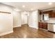 Open living space with wood-look flooring connected to a kitchen and entryway at 4303 Cowslip Ct, Indianapolis, IN 46203