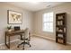 Bright office space includes a modern desk setup and a bookshelf perfect for remote work or studying at 4303 Cowslip Ct, Indianapolis, IN 46203