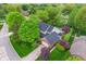 Aerial view of home, lush landscaping, inground pool, mature trees, and well-manicured lawn at 4401 W Hunters Ridge W Ln, Greenwood, IN 46143