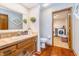 Bathroom with vanity, tiled countertops, and view to the laundry room at 4401 W Hunters Ridge W Ln, Greenwood, IN 46143