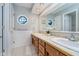 Bright bathroom with white wainscoting, window with octagonal panes, and double sink vanity at 4401 W Hunters Ridge W Ln, Greenwood, IN 46143