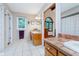 Bathroom with white tile floors, oak vanity and open view to main bedroom at 4401 W Hunters Ridge W Ln, Greenwood, IN 46143