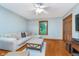 Bedroom featuring a comfortable sofa, ottoman, hardwood floors and ceiling fan at 4401 W Hunters Ridge W Ln, Greenwood, IN 46143