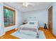 Bedroom with large window, hardwood floors and calming blue walls at 4401 W Hunters Ridge W Ln, Greenwood, IN 46143