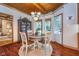 Dining area with wood-paneled ceiling, view to the back yard, and adjacent sitting room at 4401 W Hunters Ridge W Ln, Greenwood, IN 46143