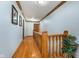 Bright hallway featuring wood floors, wood trim, and a decorative plant at 4401 W Hunters Ridge W Ln, Greenwood, IN 46143