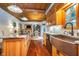 Open-concept kitchen with wood cabinets, granite countertops, island, and stainless steel sink at 4401 W Hunters Ridge W Ln, Greenwood, IN 46143