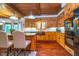 Well-lit kitchen with wooden cabinets, granite countertops, island, and stainless steel appliances at 4401 W Hunters Ridge W Ln, Greenwood, IN 46143