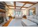 Bright living room with hardwood floors, a fireplace, and a wood-beamed ceiling that adds architectural detail at 4401 W Hunters Ridge W Ln, Greenwood, IN 46143