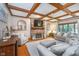 Spacious living room featuring a cozy fireplace, wood-beamed ceiling, and comfortable seating arrangements at 4401 W Hunters Ridge W Ln, Greenwood, IN 46143
