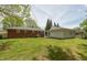 Exterior shot showcasing a brick home with a large backyard, garage, and green grass at 4468 N Elizabeth St, Indianapolis, IN 46226