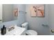 Powder room featuring a modern sink, toilet, mirror, and decorative art at 4468 N Elizabeth St, Indianapolis, IN 46226