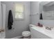 Bathroom showcasing a white vanity, toilet, dark towel, and window with natural lighting at 4468 N Elizabeth St, Indianapolis, IN 46226