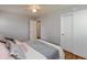 Bright bedroom featuring hardwood floors, ceiling fan, closet, and multiple pillows at 4468 N Elizabeth St, Indianapolis, IN 46226