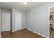 Bedroom showcasing laminate wood flooring, natural light from a window and two white doors at 4468 N Elizabeth St, Indianapolis, IN 46226