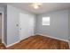 Bedroom showcasing hardwood floors, natural light from a window, and closet at 4468 N Elizabeth St, Indianapolis, IN 46226