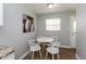 Bright dining area featuring a round table and white chairs with wood flooring at 4468 N Elizabeth St, Indianapolis, IN 46226