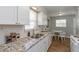 Bright kitchen with granite countertops, white cabinets, and stainless steel sink and faucet at 4468 N Elizabeth St, Indianapolis, IN 46226