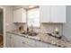 Bright kitchen featuring granite countertops, white cabinets, and modern fixtures for a clean look at 4468 N Elizabeth St, Indianapolis, IN 46226