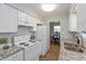 Modern kitchen with white appliances, granite countertops, and open view to dining area at 4468 N Elizabeth St, Indianapolis, IN 46226