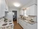 Well-lit kitchen with granite counters, white cabinets, and appliances, flowing into the dining area at 4468 N Elizabeth St, Indianapolis, IN 46226