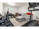 Cozy basement with a comfortable couch, piano, desk and treadmill, perfect for a relaxing or productive space at 5124 N Capitol Ave, Indianapolis, IN 46208