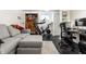 A modern, well-lit basement featuring a sofa, desk, exercise equipment, and storage closet at 5124 N Capitol Ave, Indianapolis, IN 46208