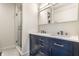 Bathroom featuring a dual sink vanity with marble countertop and a glass-enclosed shower at 5124 N Capitol Ave, Indianapolis, IN 46208
