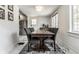 Bright dining area features a rustic wood table with gray upholstered chairs and a marble floor at 5124 N Capitol Ave, Indianapolis, IN 46208
