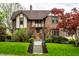 Charming brick two-story home with manicured lawn, lovely landscaping, and welcoming front steps at 5124 N Capitol Ave, Indianapolis, IN 46208