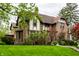 Well-maintained brick home with lush front lawn and beautiful landscaping, offering great curb appeal at 5124 N Capitol Ave, Indianapolis, IN 46208