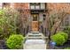 Inviting front entrance with classic wood door, brick facade, and professional landscaping at 5124 N Capitol Ave, Indianapolis, IN 46208